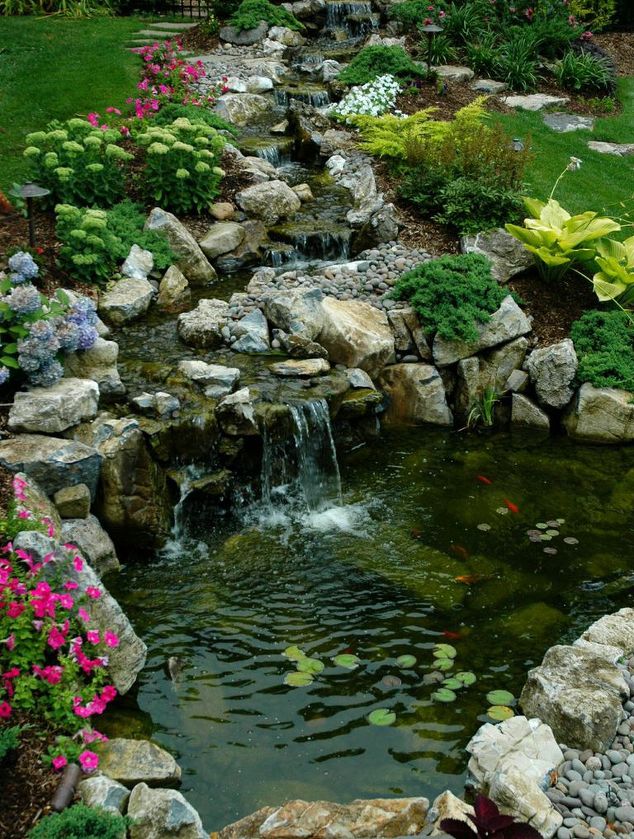 here s what people are doing with their sloped backyards, Add a bubbling pond at the bottom
