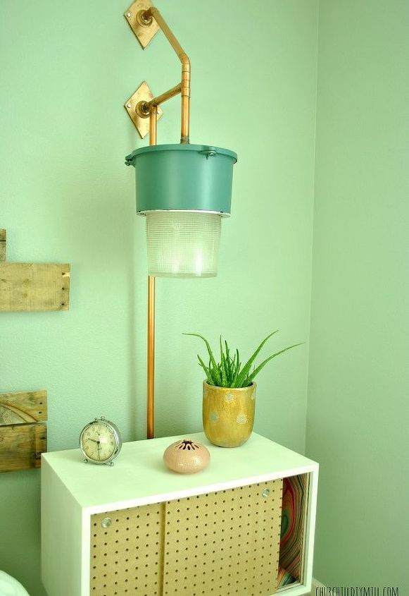 13 homemade wall sconces that double as wall decor, Use old warehouse lights and pipes