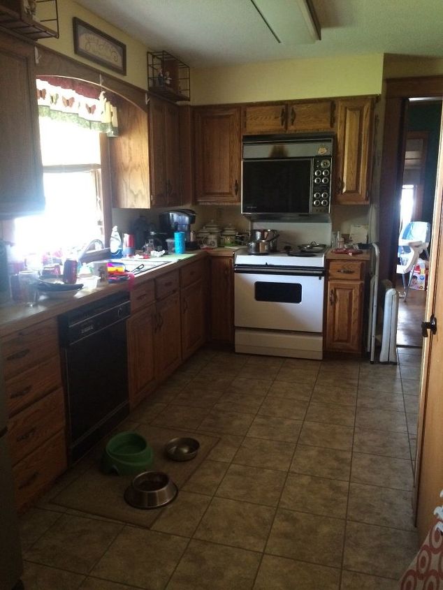 q my kitchen and i need your help can you give some very cheap ideas , countertops, kitchen cabinets, kitchen design, East and South walls swinging door to dining room next to ovens