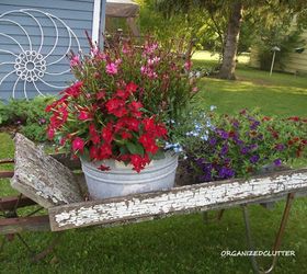 s how to transform your backyard into a junk garden, Place plants on an old worn out wheelbarrow