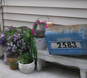 s how to transform your backyard into a junk garden, Place flowers in an old painted mailbox
