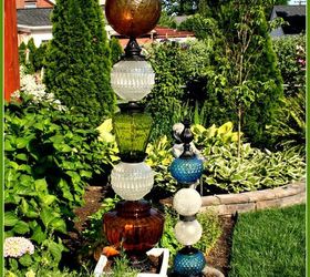 why everyone is loving these cheap glass globes, They can be stacked up into garden totems