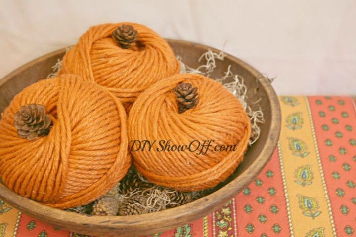 s 23 astounding ways to make a pumpkin out of anything, Stick a pinecone on an orange ball of yarn