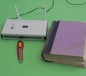 cover up your router, I found someone throwing away this damaged book It was the perfect size for this project because it s just a little bit bigger than my router