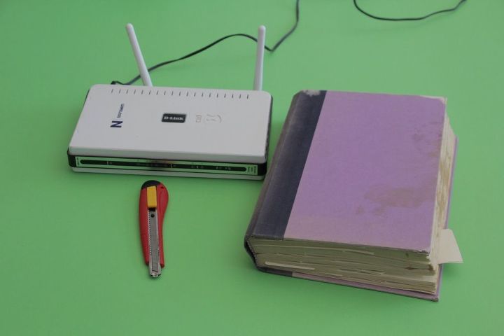 cover up your router, I found someone throwing away this damaged book It was the perfect size for this project because it s just a little bit bigger than my router