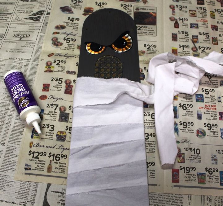 make a halloween mummy from a ceiling fan blade, halloween decorations, repurposing upcycling, seasonal holiday decor, wall decor, Add eyes Wrap blade with strips or gauze