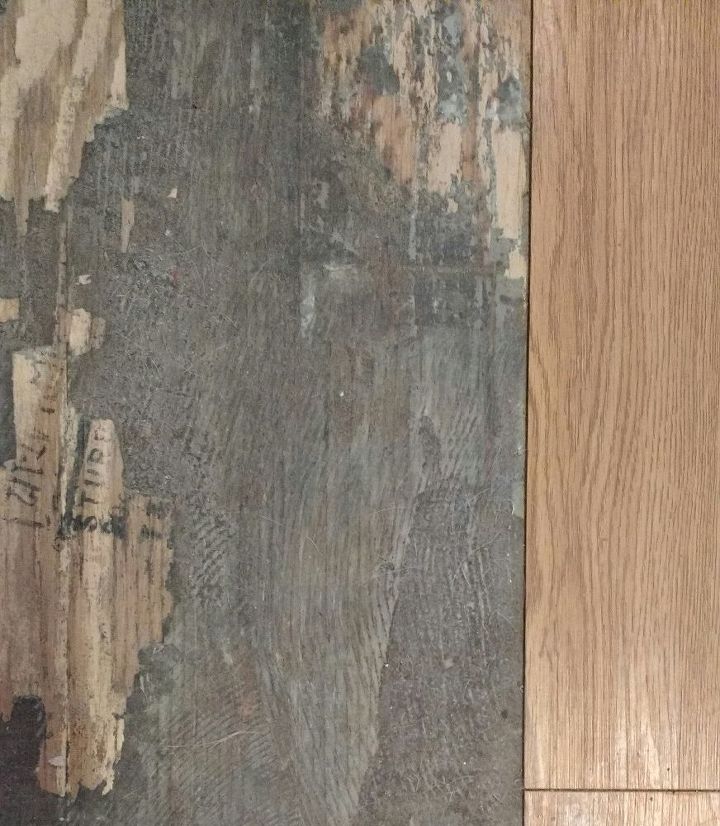 removing glue from vinyl plank flooring, The gray is the dried glue You can see where I ve scraped some off the plywood subflooring