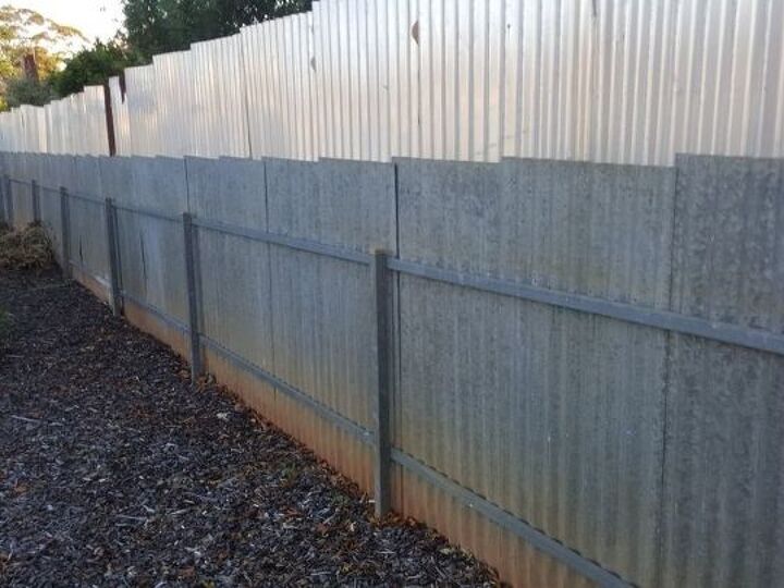 q backyard side fence very ugly, fences, My boundary side fence showing my side and the sheet metal my neighbor attached to his sidr so that he didn t have to pay half the cost to replace it
