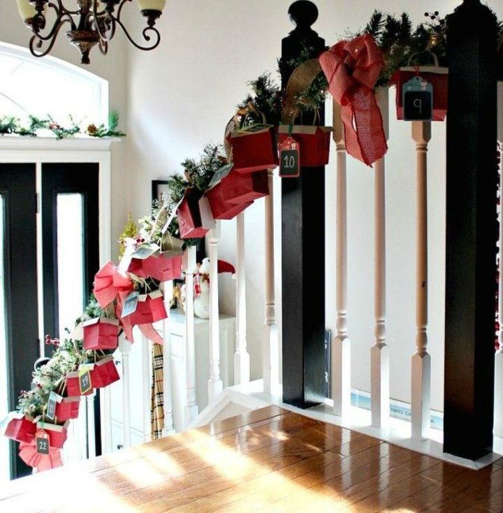 s 25 advent calendar ideas that are so cute, This stairwell garland one with mini boxes