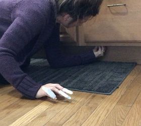 Mom sticks Command hooks under her kitchen cabinet for a clever trick