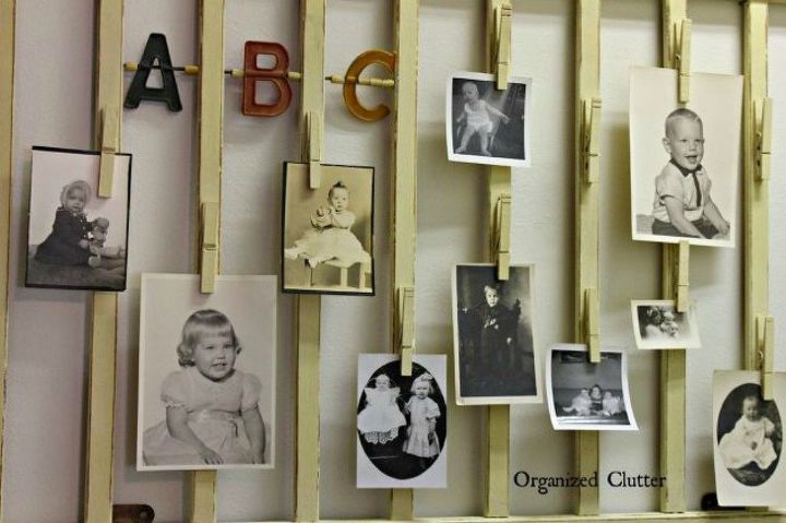 s show off your family photos with these 16 creative ideas, Clip them onto an old crib rail