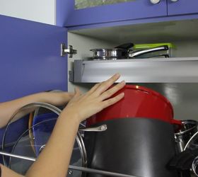 Mom sticks command hooks in her kitchen cabinet for a brilliant trick