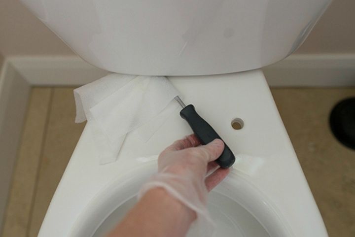 s how to keep dirty bathroom spots clean and fresh much longer, bathroom ideas, cleaning tips, Scrub your toilet with a screwdriver wipe