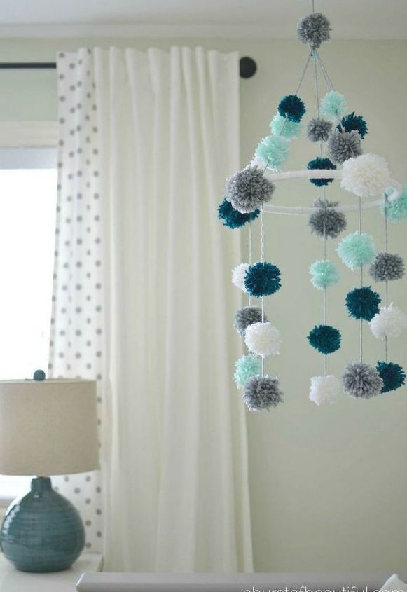 15 ultimate ways to use embroidery hoops in your home decor, Refit it as a pom pom baby mobile