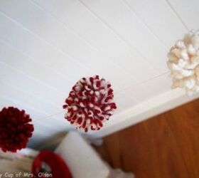 s yarn bomb your home with these 18 adorable ideas, home decor, String them into a pom pom garland