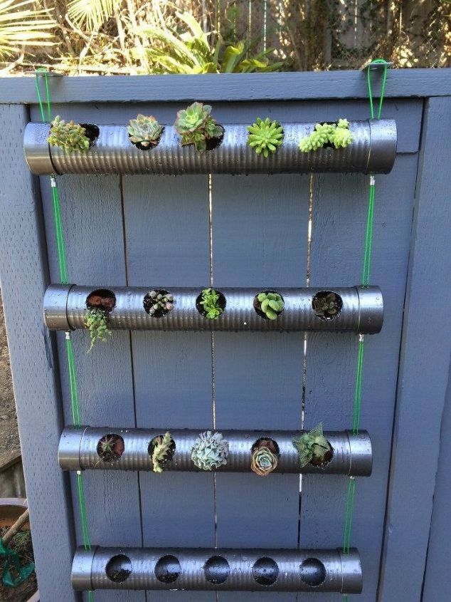 the 15 coolest ways to reuse pipes in your home decor, Drill holes into them for a hanging planter