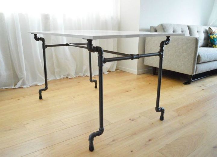 the 15 coolest ways to reuse pipes in your home decor, Stabilize a table with industrial pipes
