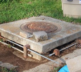 what is the best way to hide a sewer drain put in my yard by city