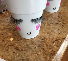 guess what makes these terra cotta pots so cute false eyelashes