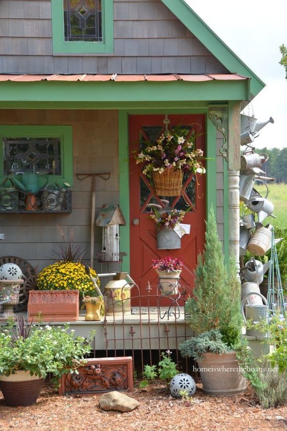 hang a collection of watering cans to decorate a garden shed