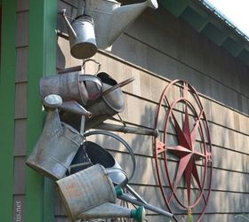 hang a collection of watering cans to decorate a garden shed
