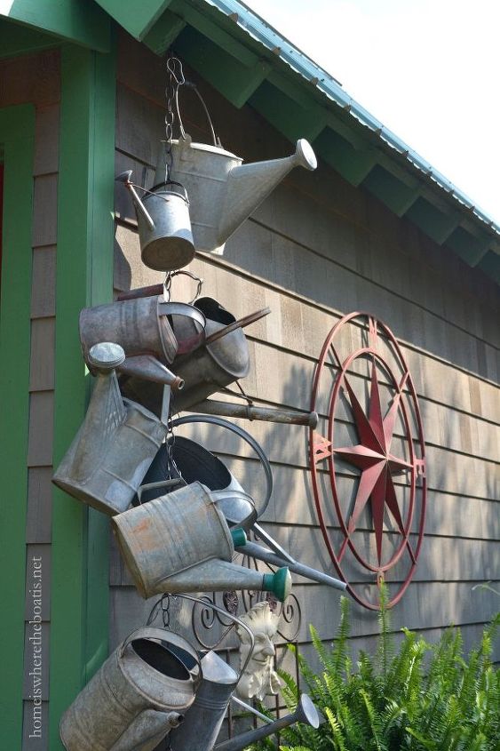 hang a collection of watering cans to decorate a garden shed