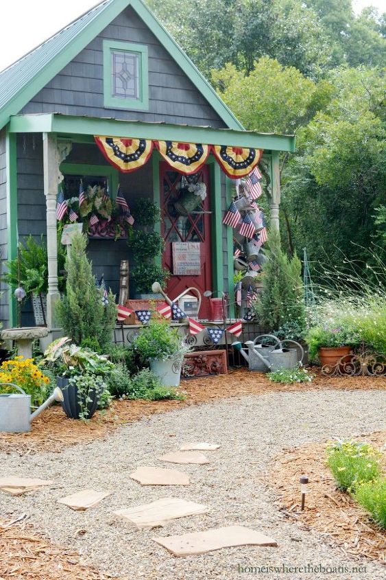 hang a collection of watering cans to decorate a garden shed