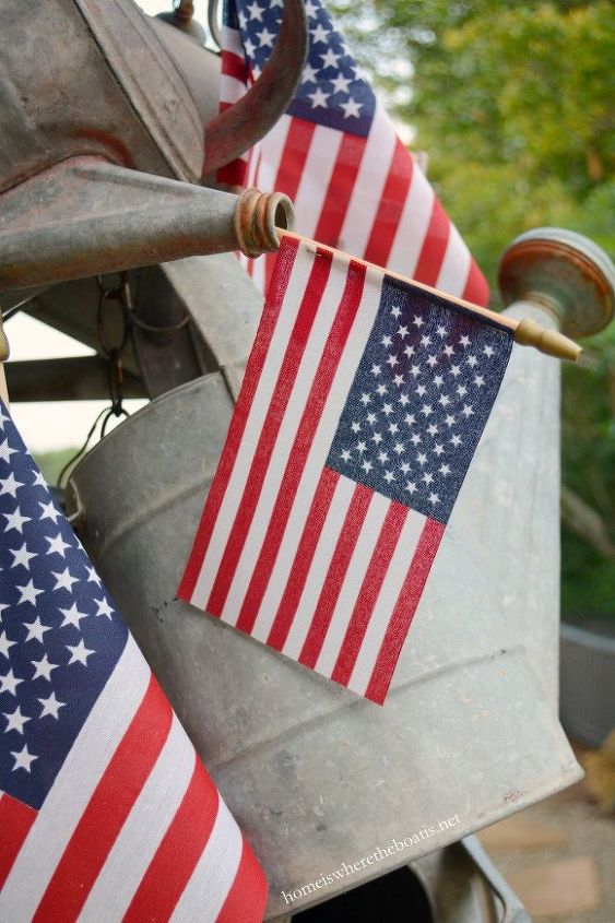 hang a collection of watering cans to decorate a garden shed