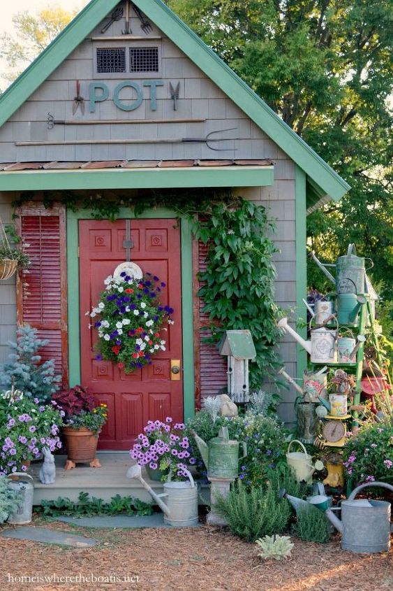 hang a collection of watering cans to decorate a garden shed