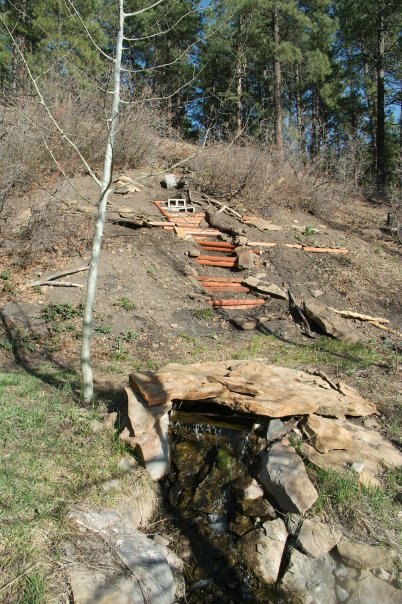 how to build a backyard waterfall up a slope, foundation of treated timber and cement block