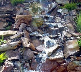 how to build a backyard waterfall up a slope, Rocks and plants work in process