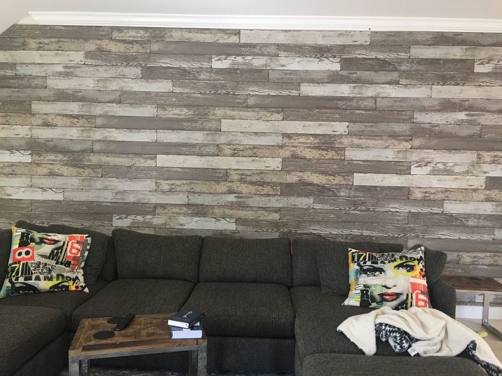 q any suggestions on how to decorate this large faux wood wall