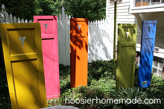 s 30 garden art ideas to fall in love with, Stand Spray Painted Shutters In Your Garden