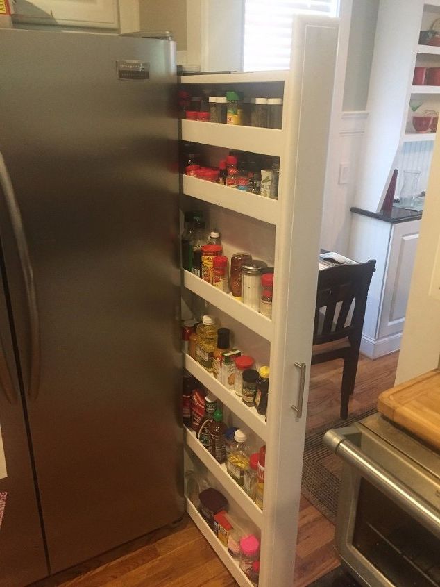 custom pull out spice rack tucked on the side of our refrigerator