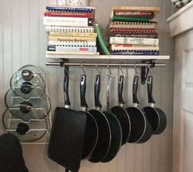 32 space saving storage ideas that ll keep your home organized, Hang your pots and pans on a rod