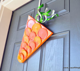 s 31 fabulous wreath ideas that will make your neighbors smile, Create a fun carrot hanger from canning lids