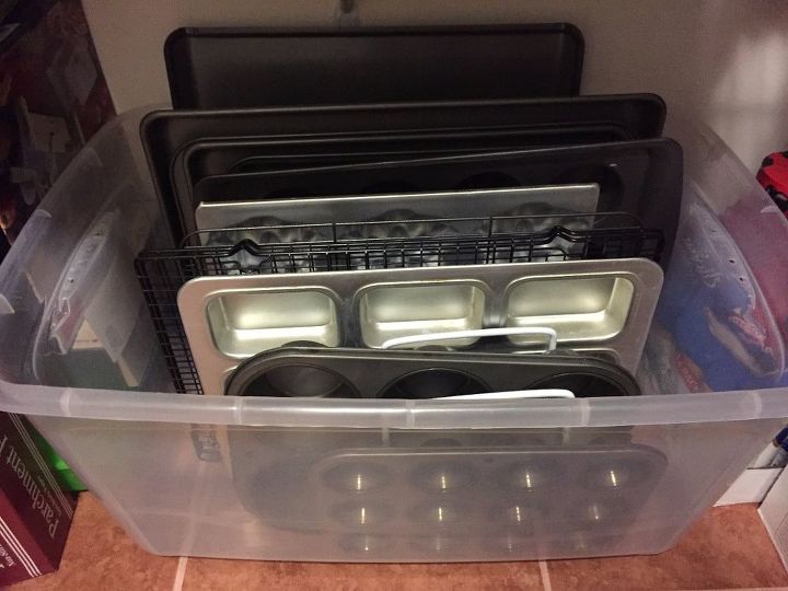 31 space saving storage ideas that ll keep your home organized, Organize your cookie sheets in a plastic bin