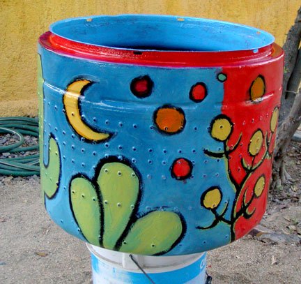 recycled washing machine drum into garden art