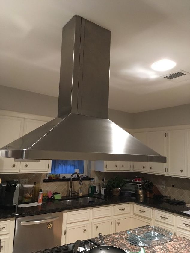 How do I raise a stove vent hood that drops down too low?