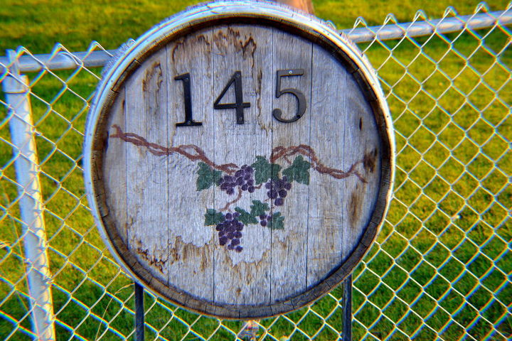 30 address signs that ll make your neighbors stop in admiration, Repurpose a wine barrel bottom