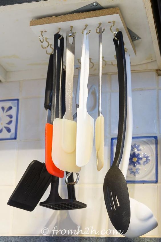 s 31 storage hacks that will instantly declutter your kitchen, Hang your cooking utensils upside down