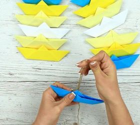s 15 uncanny hacks for making pretty garland decor, Pinch And Fold Paper Into A Boat