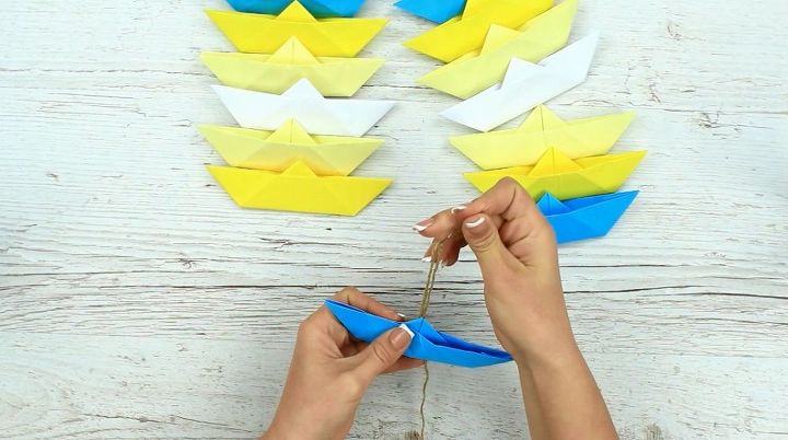 s 15 uncanny hacks for making pretty garland decor, Pinch And Fold Paper Into A Boat