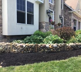 s 10 charming ways to add instant curb appeal to your home, Replace Plants Behind A Stone Wall