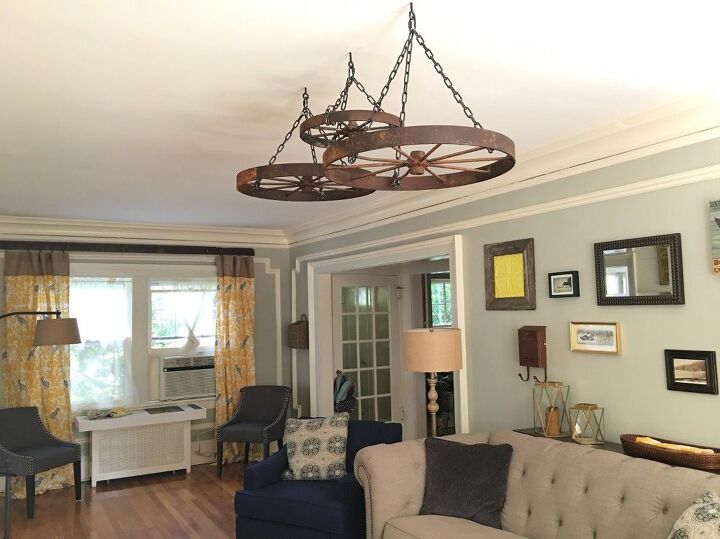 s 15 home decor projects to instantly transform your living room, Chain Wagon Wheels To The Ceiling
