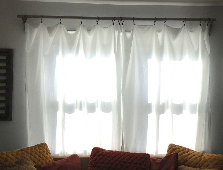 s 15 home decor projects to instantly transform your living room, Hang Sheet Curtains With A Rustic Look