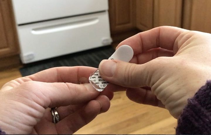 stick command hooks under your kitchen cabinets for genius lighting