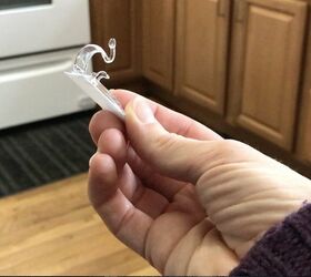 She sticks Command hooks under her lower cabinets for this brilliant update