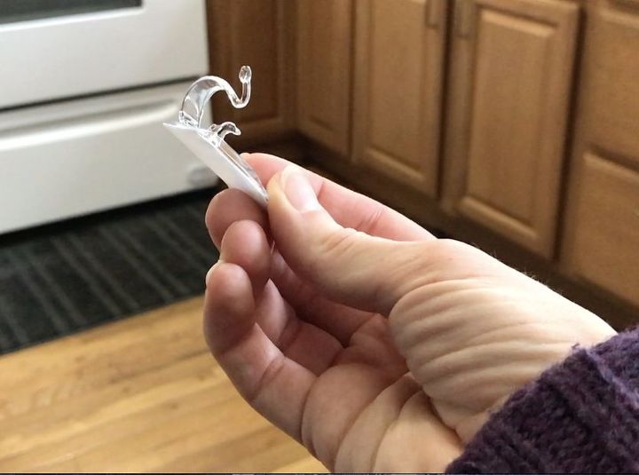 stick command hooks under your kitchen cabinets for genius lighting