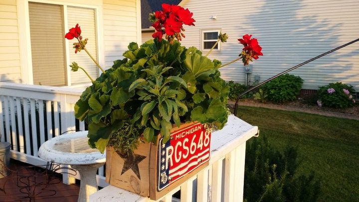 old license plates lying around check out these 28 snazzy decor ideas, Couple Your Flowers With A Matching Planter